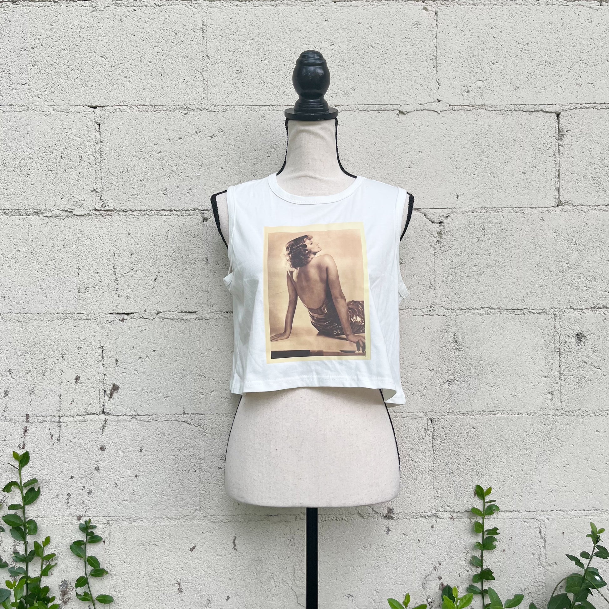 Elevate your style with our unique 1 of 1 curated retro printed tank - wearable art designed exclusively for you. This is a 100% cotton sustainably sourced tank that has been decorated with a retro 1920's print of Great Garbo. Size small, with an oversize feel. 