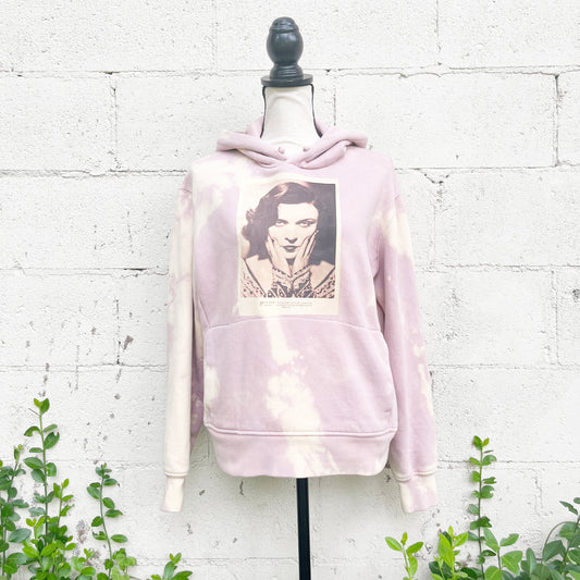 Colorful upcycled tie dye hoodie made from recycled materials. Vibrant pink hues create a unique and eye-catching design. This sustainable fashion piece is perfect for eco-conscious individuals seeking a stylish and eco-friendly addition to their wardrobe